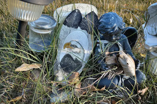 Eagle carving and cherub figure at a grave in Lebret